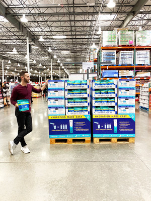 Brandin Cohen, founder and CEO of Liquid I.V., stands with palettes of Hydration Multiplier at Costco.