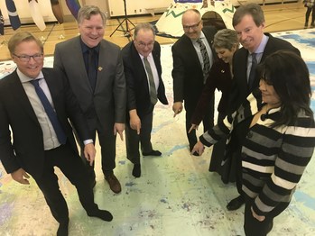 From left to right: Minister David Eggen Minister of Education, Minister Richard Feehan Minister of Indigenous Relations, Minister Brian Mason, Assistant Superintendent, Learning Services Enhancement Joe Naccarato Edmonton Catholic School District, Trustee Carla Smiley Edmonton Catholic School District, John Geiger, CEO, RCGS, and AFN Alberta Regional Chief Marlene Poitras gather on the Indigenous Peoples Atlas of Canada Giant Floor Map and locate their home on the map. Photo: Amol Dhillon (CNW Group/Royal Canadian Geographical Society)