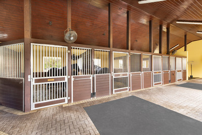 A 12-stall barn features brick aisles, tongue-and-groove ceilings and a fly-deterrent system, in addition to separate laundry, feed & tack rooms. There are also 8 large paddocks on site. More at WellingtonLuxuryAuction.com.