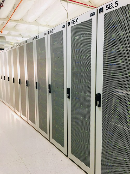 A row of fully-packed DGX cabinets inside Colovore's Santa Clara data center; there are close to 1,000 DGX-1s and DGX-2s already running at Colovore