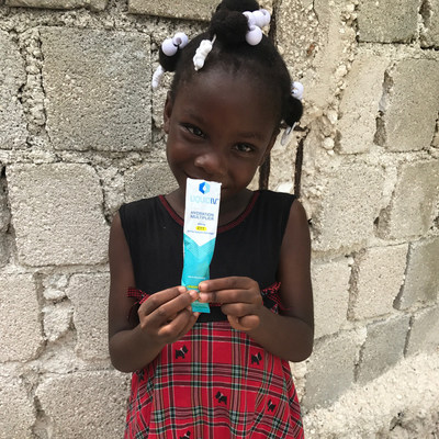 A young girl in Haiti hydrates with Liquid I.V.