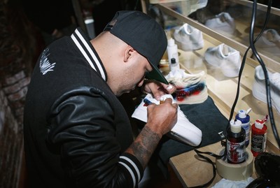 Artist Kickstradomis personalizing kicks live in Charlotte with eBay. Proceeds from his personal collection will support charity Project Fit.