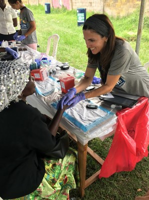Volunteer, Fátima Silva, takes a participant’s blood sample during Bridge of Life’s 2018 chronic disease screening in Uganda.
