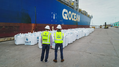 Members of Shale Support and Fracht Group observe proppant being loaded for shipment to Argentina's Vaca Muerta Shale