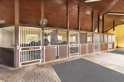A 12-stall barn features brick aisles, tongue-and-groove ceilings and a fly-deterrent system, in addition to separate laundry, feed & tack rooms. There are also 8 large paddocks on site, and a 20-meter by 60-meter mirrored riding arena (ideal for dressage). The grounds can accommodate a larger arena for hunter-jumper enthusiasts, if required. More at WellingtonLuxuryAuction.com.