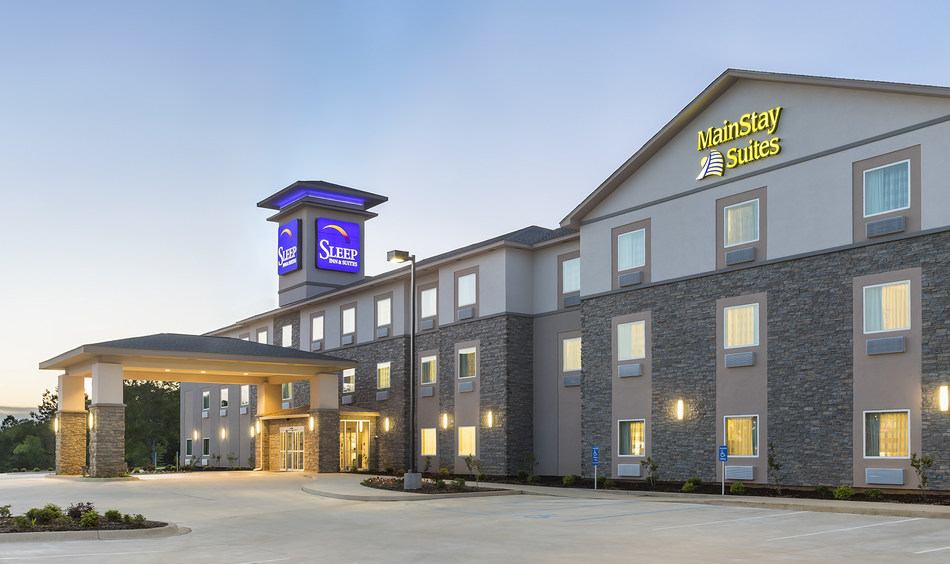 Hotel exterior at dusk with lights on