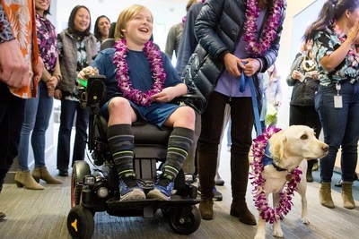 Owen and his service dog are presented with leis upon learning Owen's wish to go to Hawaii will come true. (Photo Credit: The Mark Markers)