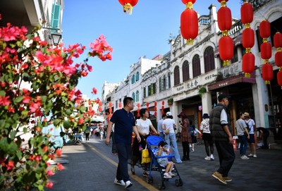 Tourists visit Qilou ancient street in Haikou, capital of south China's Hainan Province, on Feb. 6, 2019, the second day of the Chinese Lunar New Year.