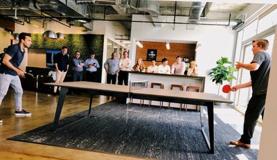 RESICAP employees enjoy a round of ping pong. A full game room, free snacks and Starbucks coffee, and a 'Never Settle' initiative are just some of the great perks that employees enjoy at the new office.