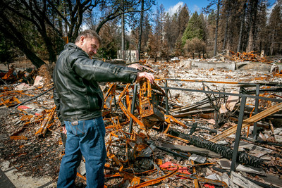 Walt Taber of the Paradise Medical Group looks at a burned computer in Paradise, Calif. on February 28th, 2019