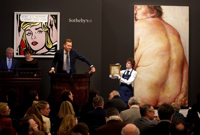 Sotheby's European Chairman and auctioneer Oliver Barker fields bids for Lucian Freud's jewel-like portrait, which led Sotheby's two-day sale series of Contemporary Art in London that achieved an overall total of $144 million.