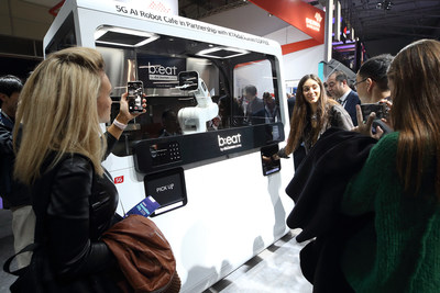 Visitors watch the 5G-powered AI robot cafe b;eat2E in action, which is co-developed by KT Corp. and Dal.Komm Coffee, at MWC 2019 held in Barcelona, Spain from Feb 25 to 28.
