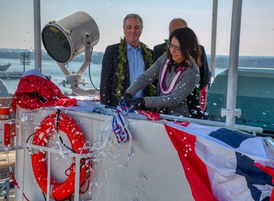 U.S. Congresswoman Tulsi Gabbard of Hawaii breaks a ceremonial bottle of champagne to christen Matson’s new containership, ‘Kaimana Hila.’