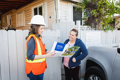 SoCalGas' Karina Esquivel, senior account executive, MHP Utility Upgrade Program, speaking with Maricela Leal, a mobile home park resident at Belmont Mobile Home Park in Compton, California, about the benefits of safe, affordable, natural gas and eligibility for customer assistance programs.