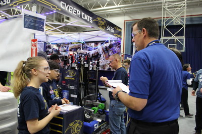 Members of the Cyber Cats Team 5436, based at Stoney Creek High School in Rochester, Michigan, discuss their ‘bot’ with the judges at a recent FIRST Robotics Competition. DENSO is one of the team’s sponsors and provides the Cyber Cats with monetary support and mentoring.