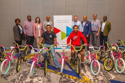 Southern Company Gas executives along with representatives from the Boys and Girls Club of Winder-Barrow display bikes built and donated during a March 28 leadership meeting.