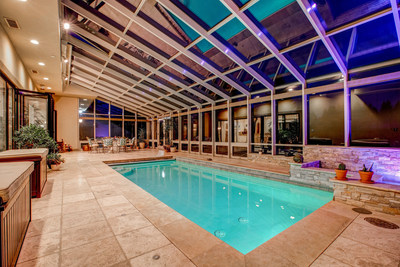 An indoor pool and spa - enclosed in glass - naturally regulates temperature via “smart” windows and shades. WashingtonLuxuryAuction.com.