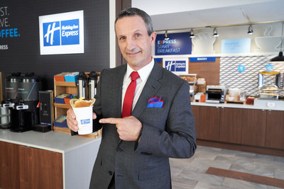 Guy Carbonneau with “The Power Play Pancake Cup,” made with fluffy pancakes shaped into a cone and filled with fresh scrambled eggs and sausage. (CNW Group/Holiday Inn Express)