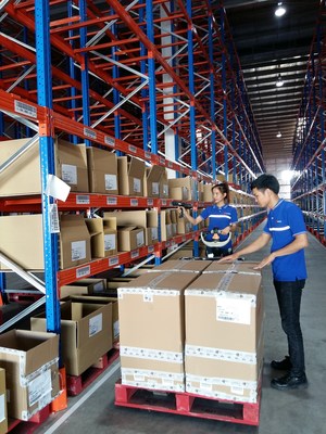 Warehouse operators scan packages at FM Logistic warehouse and DC