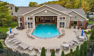 The community's clubhouse features a unique indoor-outdoor heated pool, enjoyable for residents year-round.