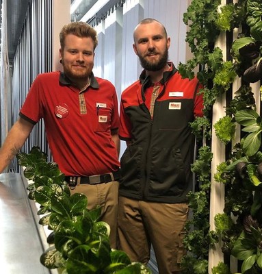 ICA Maxi Högskolan employees, Max Rydberg and Douglas Klang, now grow produce onsite for customers in Freight Farms' Leafy Green Machine.