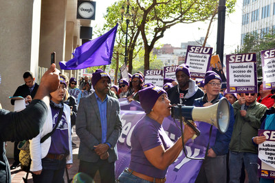 Theresa Rutherford, a San Francisco city workers and SEIU 1021 Vice President, speaks before a rally in front of Uber headquarters in a 'Distrupt Inequality' action. Citing Uber's use of foreign tax havens and calling on the company to pay its fair share towards public services, city workers, housing rights activists, and gig workers are calling on city leaders to hold SF-based gig companies accountable.