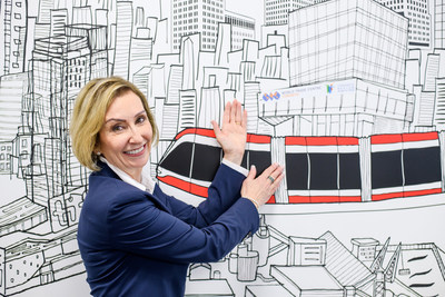 Jan De Silva, President & CEO, Toronto Region Board of Trade showcasing the World Trade Centre Toronto and the Toronto Region Board of Trade’s new home at 100 Queens Quay East on a mural in their current office. (CNW Group/Menkes Developments Ltd)