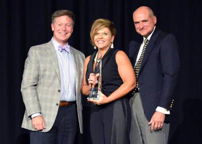 Ms. Dowm Hawley (center) is congratulated by Perkins & Marie Callender’s CEO, Jeff Warne (left) and COO, Jim Frank (right) on being named Perkins 2018 Franchisee of the Year.