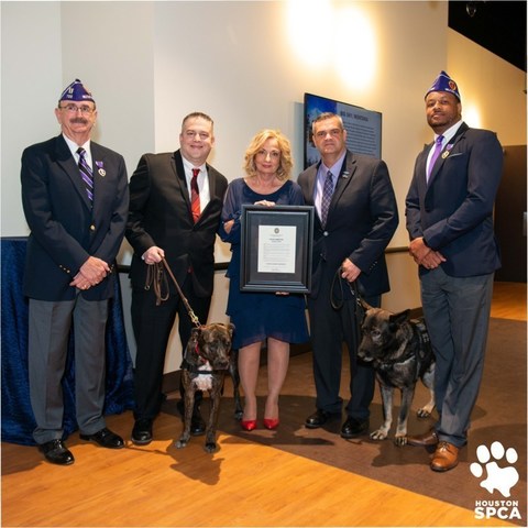 Houston SPCA is the first animal rescue organization in the country to receive Purple Heart honors for their work with veterans at a special ceremony on their Campus For All Animals in Houston. Pictured (l-r) Robert Hastings, Military Order of the Purple Heart-Houston, Coy Webb, veteran with rescue dog Emily, Houston SPCA President & CEO Patricia Mercer, Ernie Rivera, Valor Medical Service Dogs/Wins For Warriors with Xander; and Michael Matthews, Military Order of the Purple Heart-Houston.