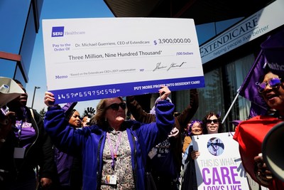 SEIU Healthcare President Sharleen Stewart attempting to present this cheque to Extendicare executives (CNW Group/SEIU Healthcare)