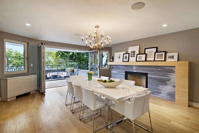 The ample dining area also opens to the upper terrace. White oak and a fireplace with Bardiglio marble finishes help create an elegant atmosphere. NewYorkLuxuryAuction.com