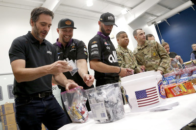 Driving legend Jimmie Johnson joins volunteers from Ally, his race team and the USO to build care packages for service members.