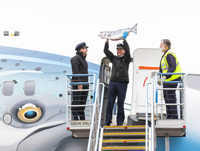 Alaska Airlines pilots hold up the first Copper River Salmon upon arrival in Seattle
