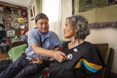 Sitting in her living room, Blue Shield of California member Juana Gutierrez gets her heart checked and oxygen level measured during a house call from Landmark Nurse Practitioner Patrick Alunan. More than 3,500 Blue Shield members with complex, chronic illnesses have enrolled during the first year of the house-calls program, which offers community-based, physician-led care in the comfort and convenience of their homes.