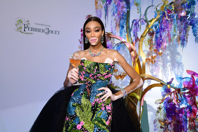 Winnie Harlow in front of the Perrier-Jouët tree designed by Bethan Laura Wood