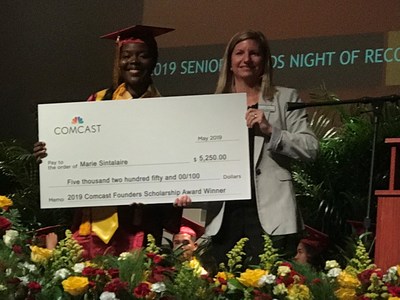 Marie Sintulaire of Belle Glade, Glades Central Community High School, receiving her Comcast Founders Scholarship check from Carla Roderick, Director of External Affairs and Community Impact for Comcast in Palm Beach County and the Treasure Coast.