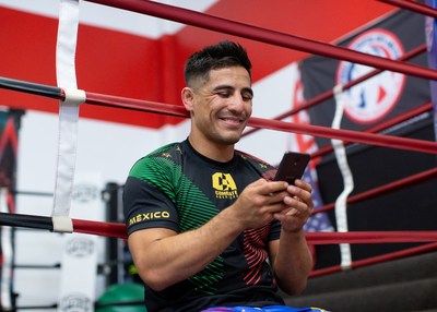 Combate Americas World Bantamweight Champion Gustavo Lopez with his Cricket Wireless phone