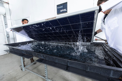PVEL technicians conduct a wet leakage test on a solar PV module as part of PVEL's thermal cycling test sequence. Wet leakage is an important safety test. Source: PVEL LLC