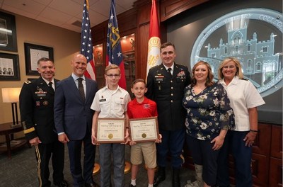 Photographed from left to right: GMC President LTG William Caldwell, NewDay USA Founder & CEO Rob Posner, students Joseph and Jacob Rousseau, parents James and Melinda Rousseau and GMC Prep Principal COL Pam Grant.