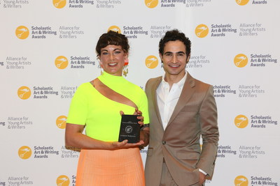 Zac Posen, fashion designer and Founder of House of Z presents the 2019 Alumni Achievement Award to Lucianne Walkowicz, astronomer at the Adler Planetarium and co-founder of The JustSpace Alliance, at the National Ceremony for the 2019 Scholastic Art & Writing Awards held at Carnegie Hall in New York, Thursday June 6, 2019.  (Stuart Ramson/AP Images for Alliance for Young Artists & Writers)