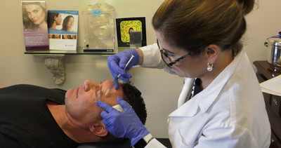 Dr. Anne Taylor, ASPS member surgeon, administers filler treatment to male patient. Male use of fillers has increased 101% since the year 2000.