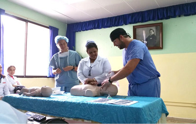 Dr. Disque (right) conducts bag valve mask training, Salcedo Government Public Hospital, Dominican Republic, 2015.
