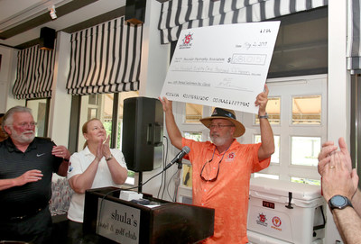 Director Steve Wemple, CEO Kara Nordstrom and COO Mark Reineri of Sailormen, Inc. present the Muscular Dystrophy Association with a check for $681,015.