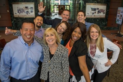 Enterprise CEO Pam Nicholson (black and white print blazer) with employees at the company’s corporate headquarters in St. Louis.