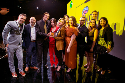 Pictured from left to right: Presenter Jeremy Delaplane with Robert Figueroa, Brent Neill, Hilary Lassoff, Loren Rochelle, Rebecca Treadwell, Cyndi Otteson, Buck Jensen, Brianna Medina, Christopher McMahon, and Arrianna Hamrah accepting the 'Startup of the Year' award by ThinkLA for NOM. (Photo credit: Christie Evans)