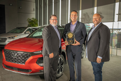 Barry Ratzlaff (right), vice president, Customer Satisfaction, Hyundai Motor America and Omar Rivera (middle), director, Quality and Service Engineering, Hyundai Motor America accept the trophy from Robert Mansfield, senior director, Global Automotive at J.D. Power for Hyundai Santa Fe's win as the top ranked midsize SUV in J.D. Power's 2019 U.S. Initial Quality Study.