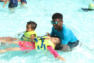 A young swimmer at Wild Wadi Waterpark in Dubai works on the back float with instructor Fahad Jamal during Thursday's World's Largest Swimming Lesson. The global event took place in 29 countries on six continents to build awareness about drowning prevention.