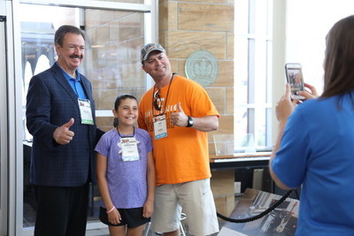 Guests pose for a photo with Sweetwater founder & CEO Chuck Surack. (June 21, 2019)