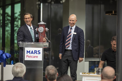 Ed Fritsch, CEO, Highwood Properties, Inc., presents a special gift to Mars Petcare North America President Mark Johnson to commemorate the grand opening of the new Mars Petcare North America Headquarters, which the company has deemed as the most pet-friendly workplace in the state.