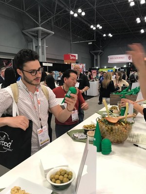 Food professionals exploring the 'Have an Olive Day' stand at the 'Summer Fancy Food Show'.